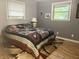 Bedroom featuring gray walls, hardwood floors, and two windows for natural light at 1927 E 125 S, Franklin, IN 46131
