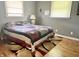 Bedroom featuring gray walls, hardwood floors, and two windows for natural light at 1927 E 125 S, Franklin, IN 46131