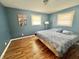 Bedroom with two windows, hardwood floors, light-blue walls, and an updated ceiling fan at 1927 E 125 S, Franklin, IN 46131