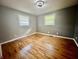 Bedroom with new hardwood floors, ceiling fan, and two large windows at 1927 E 125 S, Franklin, IN 46131