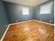 Spacious bedroom featuring light-blue walls, white trim, and new hardwood floors at 1927 E 125 S, Franklin, IN 46131
