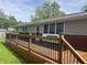 Wooden deck with black metal railings, offering outdoor space and curb appeal to the home at 1927 E 125 S, Franklin, IN 46131