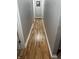 A long hallway with hardwood floors leading to multiple rooms at 1927 E 125 S, Franklin, IN 46131