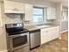 A fully equipped kitchen with modern stainless steel appliances and tiled backsplash at 1927 E 125 S, Franklin, IN 46131
