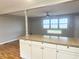 A large kitchen island with granite countertop, seating, and views of the open living room at 1927 E 125 S, Franklin, IN 46131
