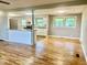 Open-concept living area with hardwood floors, flowing into a kitchen with updated cabinets and counters at 1927 E 125 S, Franklin, IN 46131