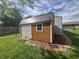 Cozy storage shed featuring a brown metal roof, double doors, and complementary brick accents at 1927 E 125 S, Franklin, IN 46131