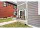 Back porch with outdoor seating, a sliding glass door, and modern lighting at 2024 Yandes St, Indianapolis, IN 46202