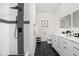 Modern bathroom with dual vanity, sleek black fixtures, and patterned tile in the shower at 2024 Yandes St, Indianapolis, IN 46202