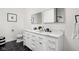 Stylish bathroom featuring a double vanity, sleek fixtures, and a modern, geometric tile floor at 2024 Yandes St, Indianapolis, IN 46202