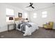Cozy bedroom with neutral decor, comfortable bedding, ceiling fan, and lots of natural light at 2024 Yandes St, Indianapolis, IN 46202