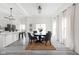 Elegant dining room with modern lighting, seating for six, and a view to the kitchen at 2024 Yandes St, Indianapolis, IN 46202