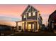 Two-story home illuminated at dusk with gray siding, vertical accents, and a covered porch at 2024 Yandes St, Indianapolis, IN 46202