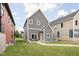 Charming two-story home features gray siding, a bright yellow door, and a well-manicured lawn and walkway at 2024 Yandes St, Indianapolis, IN 46202