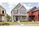 Attractive two-story home boasts gray siding, white trim, and a inviting covered front porch at 2024 Yandes St, Indianapolis, IN 46202