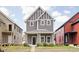 Attractive two-story home boasts gray siding, white trim, and a inviting covered front porch at 2024 Yandes St, Indianapolis, IN 46202