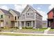 Attractive two-story home boasts gray siding, white trim, and a inviting covered front porch at 2024 Yandes St, Indianapolis, IN 46202