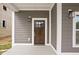 Inviting home featuring a dark wood front door, sidelight windows and modern exterior lighting at 2024 Yandes St, Indianapolis, IN 46202