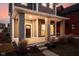Charming front porch features sturdy columns, wood ceiling, and a classic dark wood front door at 2024 Yandes St, Indianapolis, IN 46202