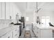 A modern kitchen features white cabinets, stainless appliances, an island with sink and room to gather at 2024 Yandes St, Indianapolis, IN 46202