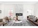 Chic living room with a modern fireplace, neutral tones, and ample natural light at 2024 Yandes St, Indianapolis, IN 46202