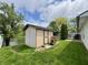 Charming backyard shed with a tranquil pond view, a lush lawn, and a deck, perfect for relaxation at 204 Meadow Creek S Dr, Whiteland, IN 46184