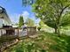 Backyard featuring a deck, lush lawn, and waterfront view, providing a serene outdoor living space at 204 Meadow Creek S Dr, Whiteland, IN 46184