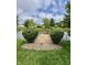Scenic backyard with a small wooden dock, landscaping, and a serene pond view, enhancing outdoor living at 204 Meadow Creek S Dr, Whiteland, IN 46184