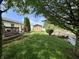 Spacious backyard with a shed, patio, lush grass, and pond access for outdoor enjoyment and storage at 204 Meadow Creek S Dr, Whiteland, IN 46184