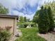 Picturesque backyard featuring a shed with charming landscaping, overlooking a tranquil pond and lush greenery at 204 Meadow Creek S Dr, Whiteland, IN 46184