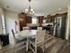 Well-appointed kitchen featuring stainless steel appliances, wood cabinetry and a round dining table at 204 Meadow Creek S Dr, Whiteland, IN 46184