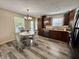 Bright eat-in kitchen features stainless appliances, dark wood cabinets, stylish lighting and wood flooring at 204 Meadow Creek S Dr, Whiteland, IN 46184