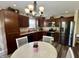 Modern kitchen with stainless steel appliances, wood cabinetry, and a cozy dining area at 204 Meadow Creek S Dr, Whiteland, IN 46184