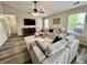 Spacious living room featuring a cozy seating area, large windows, and ample natural light at 204 Meadow Creek S Dr, Whiteland, IN 46184