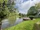 Picturesque waterfront view featuring a tranquil pond and lush greenery, creating a serene outdoor escape at 204 Meadow Creek S Dr, Whiteland, IN 46184