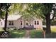 Charming bungalow with mature trees, quaint front porch, and neatly manicured lawn at 2100 N Janney Ave, Muncie, IN 47304