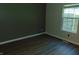 Bedroom featuring new wood floors, baseboard trim, and a window for natural light and ventilation at 2116 Galaxy Dr, Franklin, IN 46131