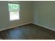 Cozy bedroom with wood floors, baseboard trim, and a window providing natural light at 2116 Galaxy Dr, Franklin, IN 46131