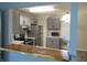 Modern kitchen featuring gray cabinets, stainless steel appliances, a breakfast bar, and natural light at 2116 Galaxy Dr, Franklin, IN 46131