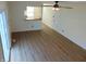 Open-concept living room with wood floors, a ceiling fan, and sliding glass doors to the outdoor area at 2116 Galaxy Dr, Franklin, IN 46131
