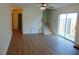 Spacious living room featuring wood floors, a ceiling fan, sliding glass doors, and an open staircase at 2116 Galaxy Dr, Franklin, IN 46131