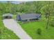 Expansive property featuring a well-maintained lawn, outbuilding, and gravel driveway, offering ample space and privacy at 2935 N Grizzly Ln, Martinsville, IN 46151