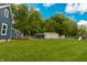 Large, flat backyard features a storage shed, carport, playset, and plenty of space for outdoor activities at 2935 N Grizzly Ln, Martinsville, IN 46151