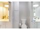 Well-lit bathroom featuring a toilet and dual vanities, each with mirrors and fixtures at 2935 N Grizzly Ln, Martinsville, IN 46151