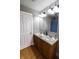 Bathroom featuring double sinks, wood floors, a large mirror, and a shower curtain at 2935 N Grizzly Ln, Martinsville, IN 46151