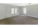 Bright bedroom featuring neutral carpet, multiple windows, and freshly painted walls at 2935 N Grizzly Ln, Martinsville, IN 46151