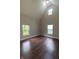 Bright bedroom with hardwood floors, high ceilings, and windows showing natural light at 2935 N Grizzly Ln, Martinsville, IN 46151