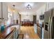 Bright and spacious kitchen featuring stainless steel appliances, a farmhouse sink, and ample counter space for meal preparation at 2935 N Grizzly Ln, Martinsville, IN 46151