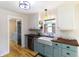 Kitchen featuring hardwood flooring, stainless steel appliances, wooden countertops, and white cabinets at 2935 N Grizzly Ln, Martinsville, IN 46151