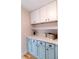 Kitchen featuring blue lower cabinets, white upper cabinets, and a white countertop at 2935 N Grizzly Ln, Martinsville, IN 46151